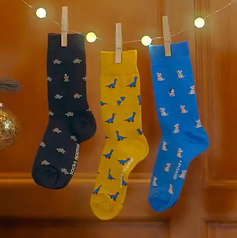 Socks hanging from a string of lights.